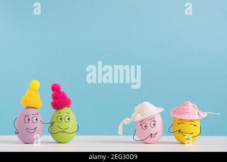 Easter holiday concept with cute eggs with funny faces. Different emotions and feelings. Guys want to meet girls. Stock Photo
