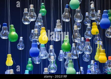 Multi-colored bulbs hanging from the ceiling Stock Photo