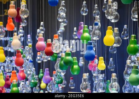 Multi-colored bulbs hanging from the ceiling Stock Photo
