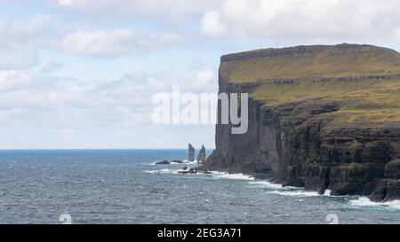 Risin and Kellingin rocks as seen from Tjornuvik bay with waves hitting the shore on Streymoy on the Faroe Islands, Denmark, Europe Stock Photo