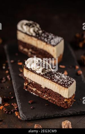 Piece of delicious homemade cake served on black slate Stock Photo