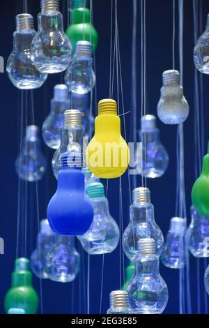 Multi-colored bulbs hanging from the ceiling Stock Photo