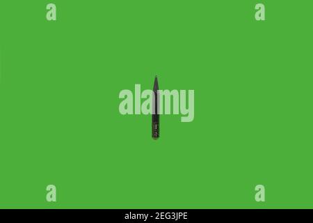 Black used pencil isolated on a green background Stock Photo