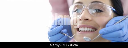 Young woman at dentist's office with instruments in her hands Stock Photo