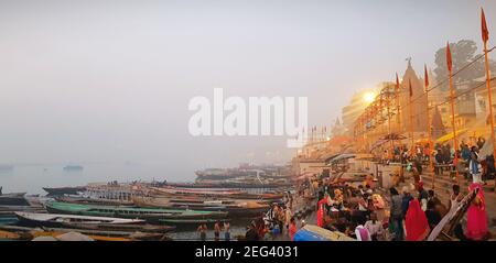 Bank of ganges river at Varanasi in the early morning people gathered for praying Stock Photo