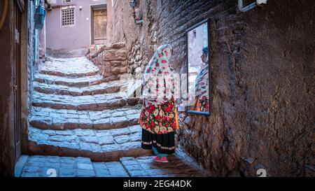 Abyaneh, Iran - May 2019: Unidentified Iranian woman with traditional Abyaneh Persian dress Stock Photo