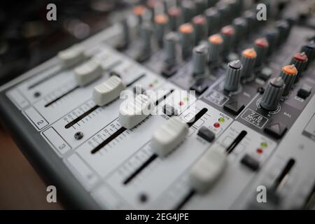 Shallow depth of field (selective focus) image with the controls on an audio mixer Stock Photo