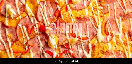 sliced whole pepperoni pizza with salami, cheese, cherry tomato Stock Photo
