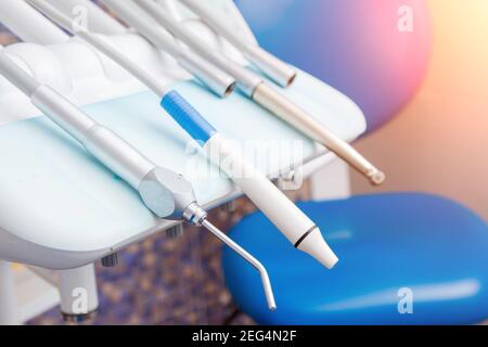 Stomatological instrument in dentists clinic. Tools drill, treat a dentist on white blue background. Stock Photo