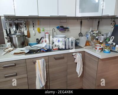 dirty dishes in the kitchen, disconnections and interruptions in the water supply, a sloppy hostess. Stock Photo