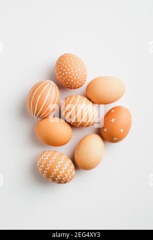 Modern Easter eggs on white background. Flat lay, top view. Simple, nordic style. Stock Photo