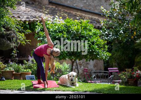 Woman in her 50's doing online yoga Stock Photo