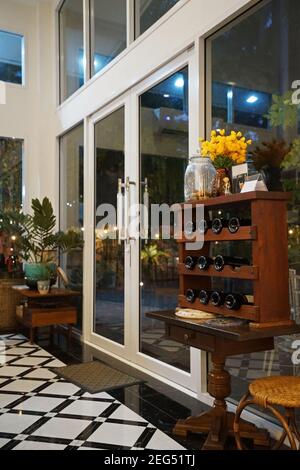 Interior design and decoration of restaurant and cocktail lounge decorated with wooden wine rack and indoor green plant pots Stock Photo