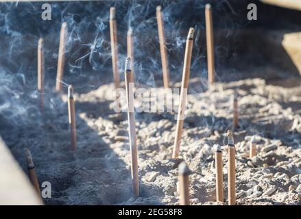 Smoke from burning incense sticks in a large caldron koro burner or censer at a Buddhist temple in Kyoto, Japan. Stock Photo