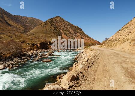 The A367 highway runs along the Kokemeren River in the Jayyl District. Kyrgyzstan. Stock Photo