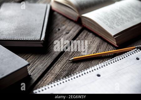 Business concept, ideas, books and exercise book on a wooden background with pencils Stock Photo