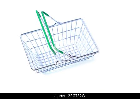 Metal shopping basket with green handles on white background Stock Photo
