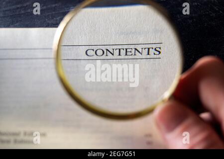 Loupe magnifying word "contents" on a technical book. Concept for business, communication, internet, advertising Stock Photo