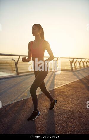 Beautiful women working out in a city. Running, jogging, exercise