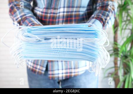 man hand holding stack of surgical face mask, Stock Photo