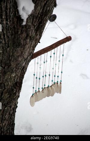 Hand made wind chimes hanging on a string with depth of field