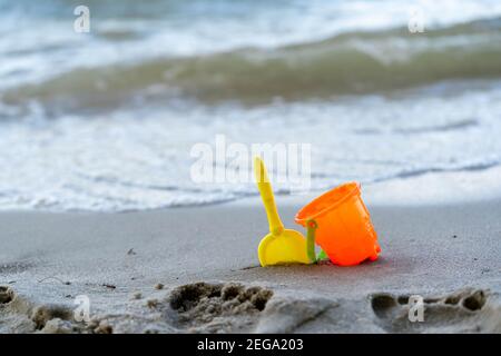 Children's beach toys - buckets, spade and shovel on sand on a sunny day Stock Photo