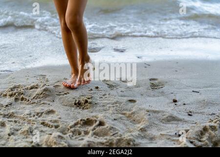 Closeup of a person's or child's feet walking on the beach, focus on arch of foot