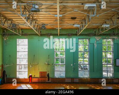 Zielona Gora June 9 2019 Empty dirty ruined gym hall in old school with punching bags Stock Photo