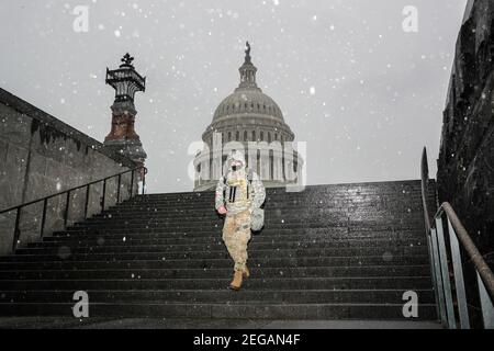 Bethesda, USA. 18th Feb, 2021. A member of the National Guard walks past the U.S. Capitol in sleet and freezing rain on Thursday, February 18, 2021, in Washington, DC. (Photo by Oliver Contreras/Sipa USA) Credit: Sipa USA/Alamy Live News Stock Photo