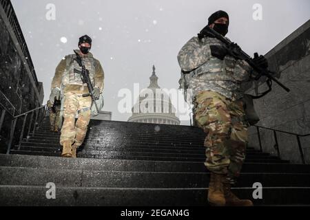 Bethesda, USA. 18th Feb, 2021. Members of the National Guard walks past the U.S. Capitol in sleet and freezing rain on Thursday, February 18, 2021, in Washington, DC. (Photo by Oliver Contreras/Sipa USA) Credit: Sipa USA/Alamy Live News Stock Photo