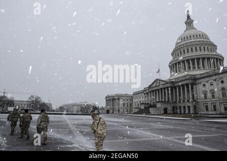 Bethesda, USA. 18th Feb, 2021. Members of the National Guard walks past the U.S. Capitol in sleet and freezing rain on Thursday, February 18, 2021, in Washington, DC. (Photo by Oliver Contreras/Sipa USA) Credit: Sipa USA/Alamy Live News Stock Photo