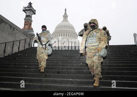 Bethesda, USA. 18th Feb, 2021. Members of the National Guard walks past the U.S. Capitol in sleet and freezing rain on Thursday, February 18, 2021, in Washington, DC. (Photo by Oliver Contreras/Sipa USA) Credit: Sipa USA/Alamy Live News Stock Photo