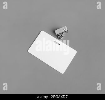 Photo of blank white plastic badge on vintage wooden table background ...