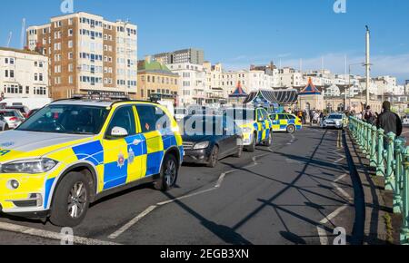 Brighton UK 18th February 2021 - Police officers close off Brighton seafront after pulling over a car causing major traffic congestion in the city . Two men have been arrested after the car had been spotted driving erratically through Sussex before being stopped by Brighton Palace Pier : Credit Simon Dack / Alamy Live News Stock Photo