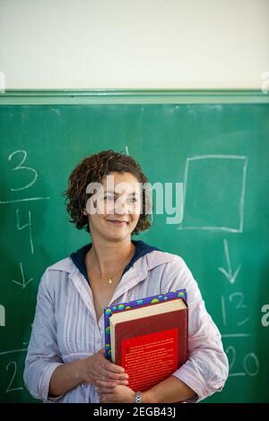 Teacher teaching her class in a school classroom Stock Photo