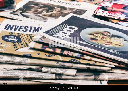 Close-up of weekend newspapers scattered on a table Stock Photo