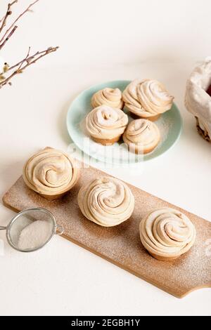 cruffins easter spring pastries, a mix of muffin and croissant on a light background, close-up for text place. Stock Photo