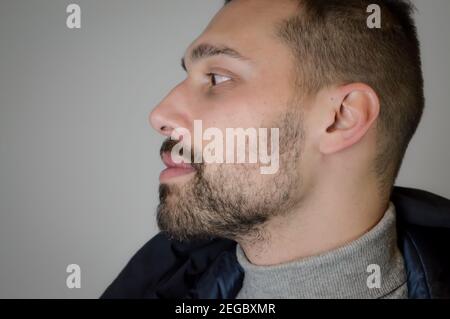 Profile portrait of a young brown-haired man with a short beard Stock Photo