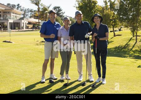 Four caucasian senior men and women looking at the camera and smiling