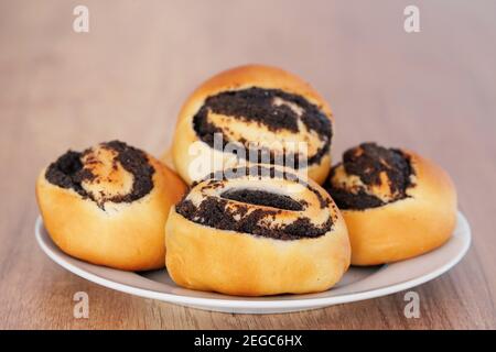 Delicious poppy seed pastries made from yeast dough. Sweet rolls with poppy seeds. Stock Photo