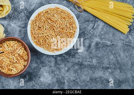 Different types of pasta on the marble background Stock Photo