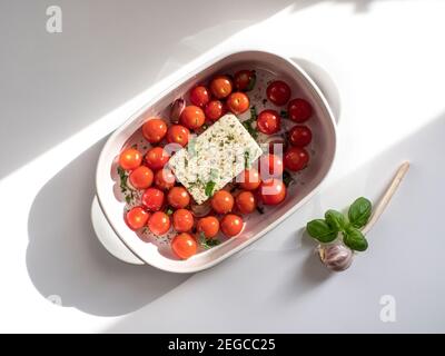 OLYMPUS DITrending viral Feta bake pasta recipe made of tomatoes, cheese, garlic and herbs in a casserole dish. Stock Photo