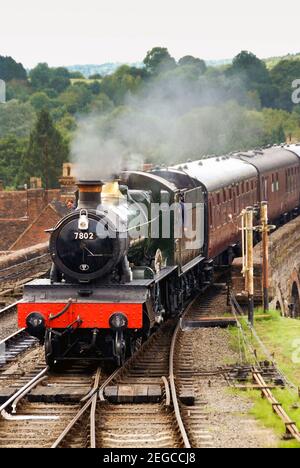 Bewdley, England - August 2016: A steam engine approaching Bewdley Station with a train of carriages Stock Photo