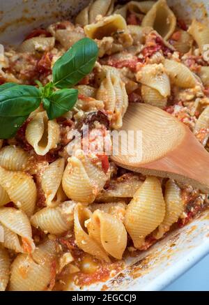 OLYMPUS DITrending viral Feta bake pasta recipe made of tomatoes, cheese, garlic and herbs in a casserole dish. Stock Photo