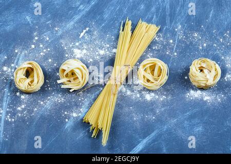 Assorted dry pasta on blue background Stock Photo