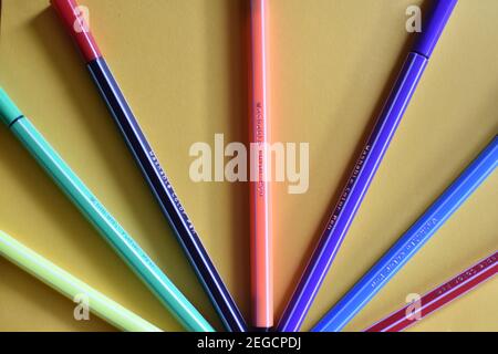 colored markers on yellow background Stock Photo