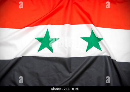 Fabric national flag of Syria as background Stock Photo
