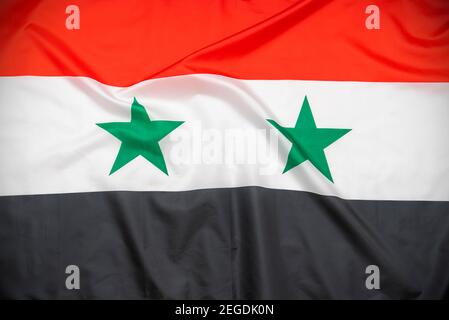Fabric national flag of Syria as background Stock Photo