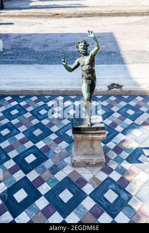 Statue of the Dancing Faun in the ruins of the ancient archaeological site of Pompeii, Italy Stock Photo