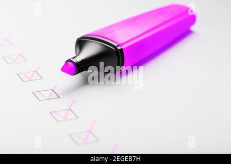 A magenta marker with markers on the control sheet. Checklist of the completed task concept. Stock Photo